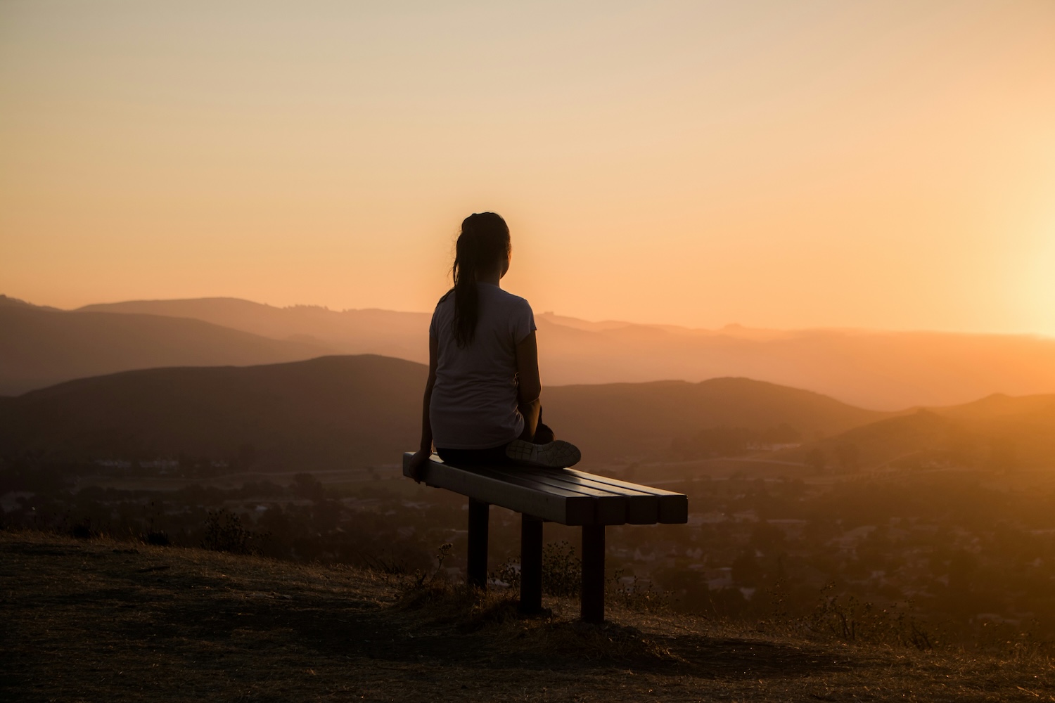 Woman meditating outdoors at sunrise